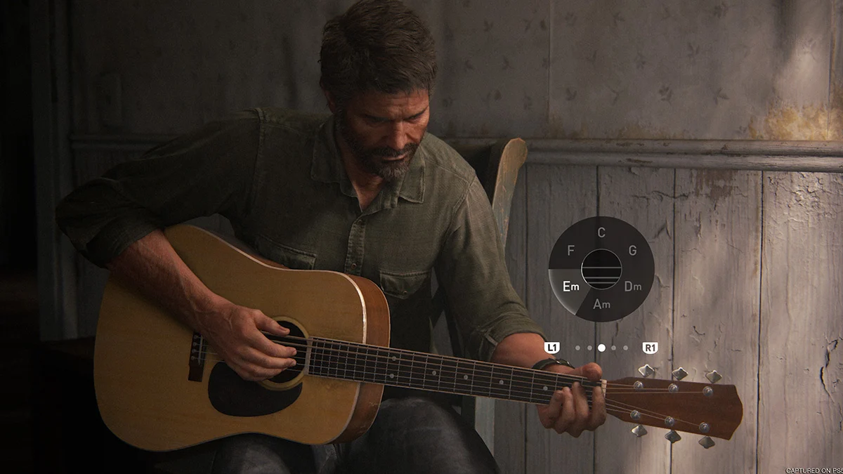 Captura The Last Of Us Part II Remastered – Ellie Observa Un Campamento Improvisado Frente Al Hospital De Seattle Con Varias Personas Reunidas Junto A Una Hoguera
