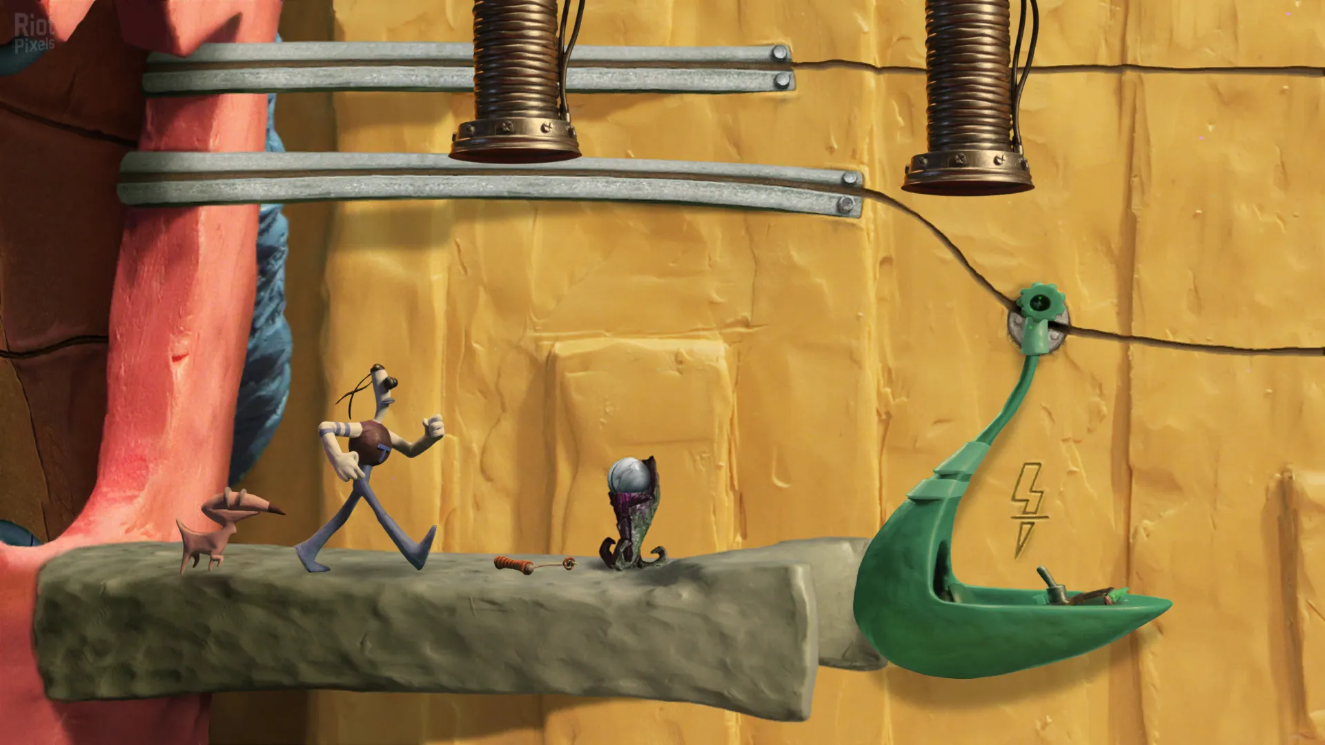 Captura The Neverhood – Escena Con Personajes Pequenos En Entorno Mecanico Y Tuberias