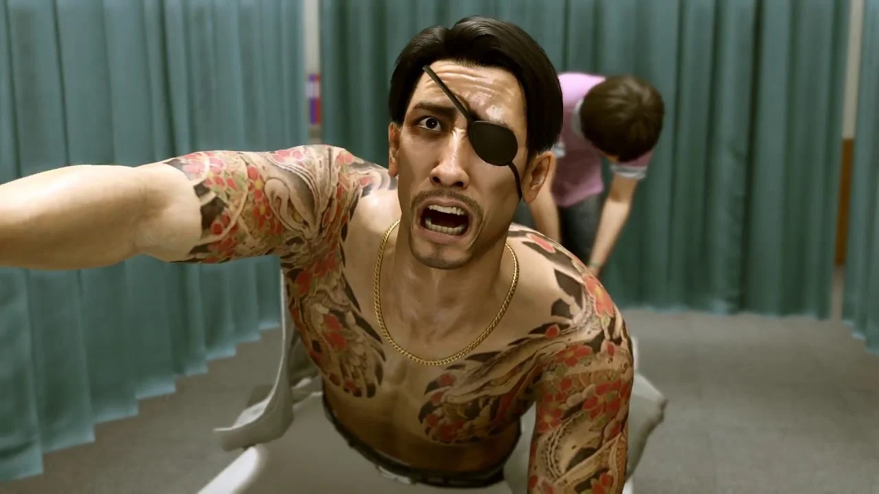 Captura Yakuza Kiwami – Majima Con Expresion De Panico Mientras Es Empujado En Una Camilla Dentro De Una Sala Medica